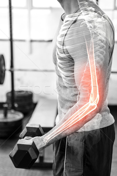 Highlighted arm of strong man lifting weights at gym Stock photo © wavebreak_media
