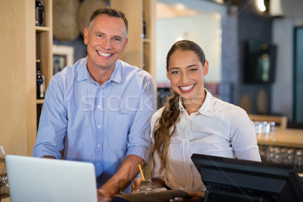 Stock photo: Smiling manager and bartender standing at bar counter