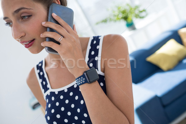 Homme exécutif parler téléphone portable bureau femme [[stock_photo]] © wavebreak_media