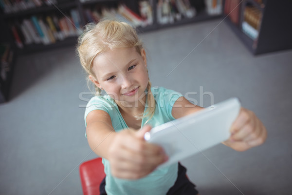 Fille téléphone portable séance bibliothèque vue [[stock_photo]] © wavebreak_media