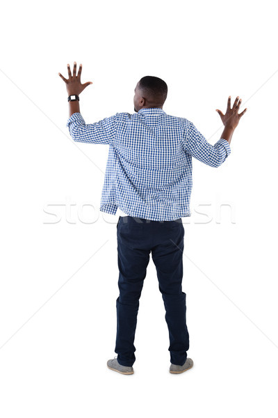 Man pretending to touch an invisible screen against white background Stock photo © wavebreak_media