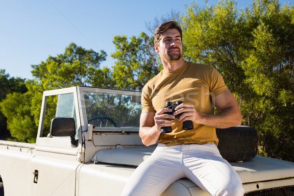 Man holding binocular on off road vehicle Stock photo © wavebreak_media