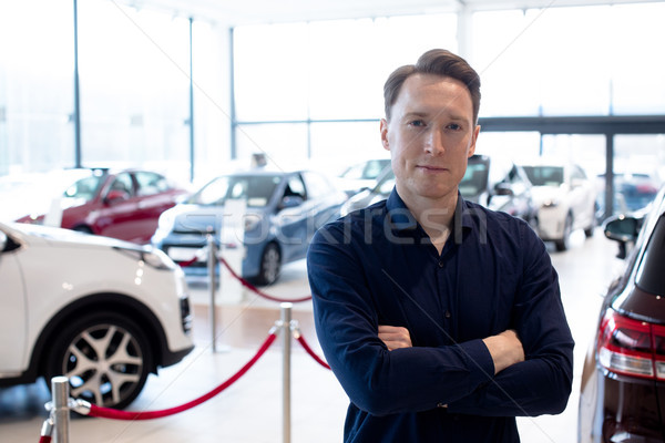 Portrait of smiling salesman standing in showroom Stock photo © wavebreak_media