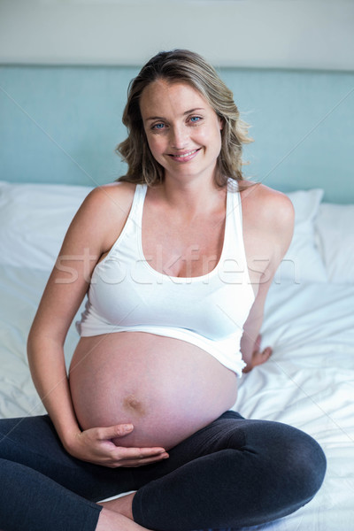 Pregnant woman resting on her bed Stock photo © wavebreak_media