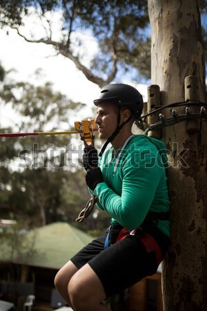 Little girl wearing helmet trying to fix her harness Stock photo © wavebreak_media