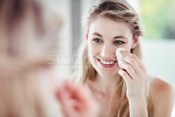 Happy young woman applying blush Stock photo © wavebreak_media