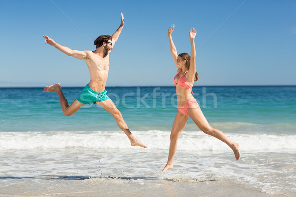 Couple sautant plage femme ciel [[stock_photo]] © wavebreak_media