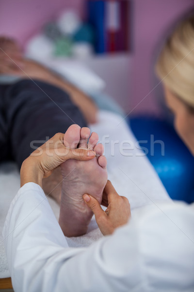 Physiotherapist giving foot massage to a patient Stock photo © wavebreak_media
