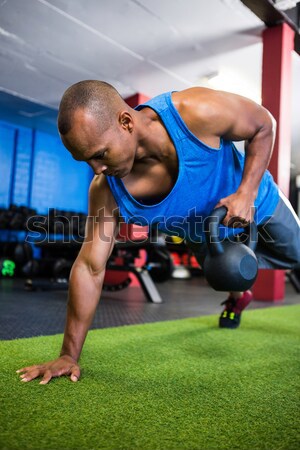 Man doing push-ups with kettlebells Stock photo © wavebreak_media