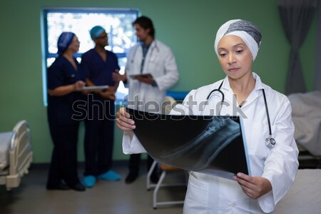 Portrait of female doctor leaning with file at the entrance of ward Stock photo © wavebreak_media