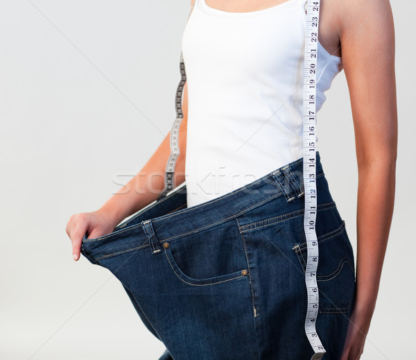 Close-up of woman wearing big jeans focus on woman  Stock photo © wavebreak_media