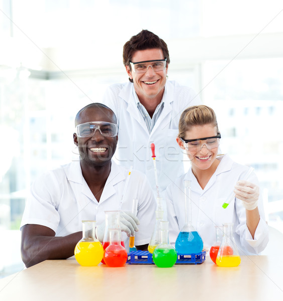 Scientists examining test-tubes smiling at the camera Stock photo © wavebreak_media