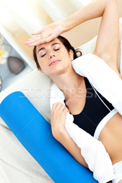 Tired hispanic woman sitting on the sofa after working out at home Stock photo © wavebreak_media