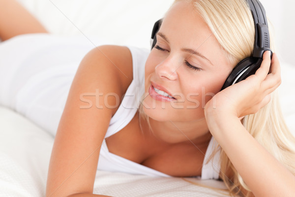 Stock photo: Woman enjoying some music in her bedroom