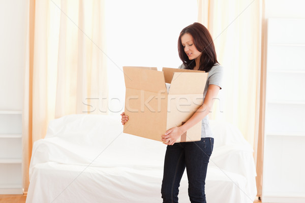 A woman is carrying a large cardboard Stock photo © wavebreak_media