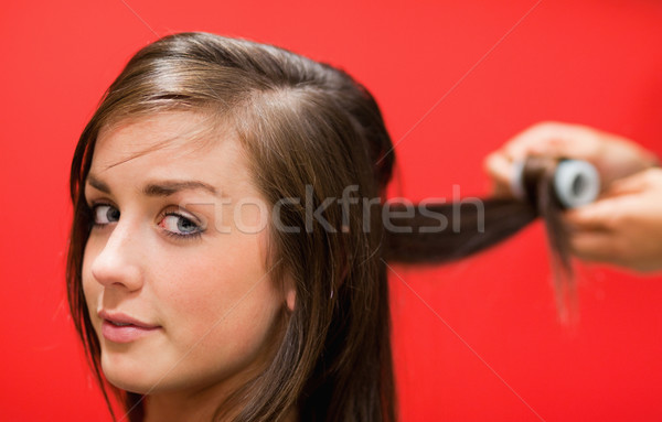Woman having her hair rolled with a curler Stock photo © wavebreak_media