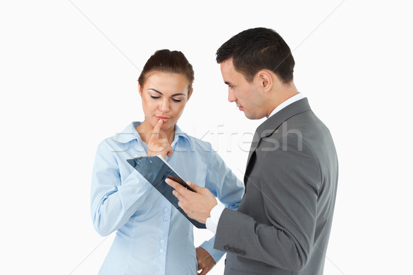 Business partners with clipboard against a white background Stock photo © wavebreak_media