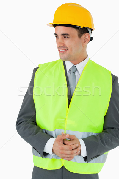 Stock photo: Architect with hands folded looking to the side against a white background