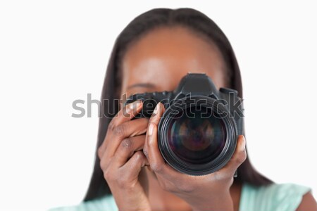 Close up of young female photographer against a white background Stock photo © wavebreak_media