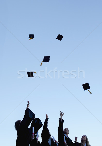 Low angle-shot of five grad students throwing their hats high in the sky  Stock photo © wavebreak_media