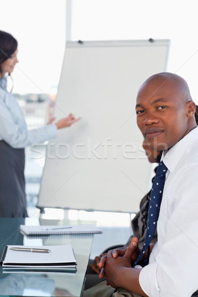 Serious executive looking at the camera during a presentation given by a co-worker Stock photo © wavebreak_media