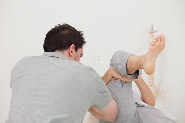 Woman stretching her leg in a physio room Stock photo © wavebreak_media