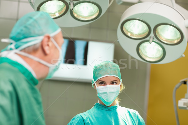Stock photo: Surgeon looking at each other in a surgical room