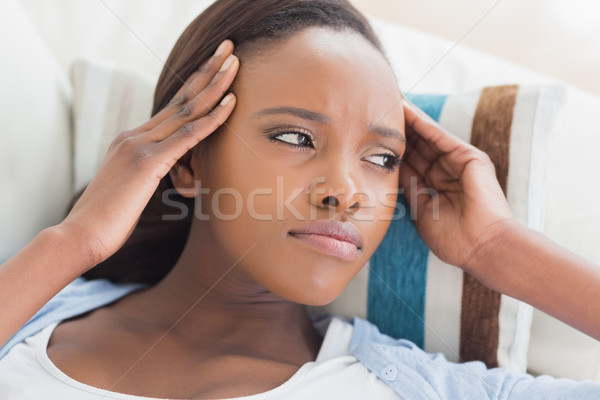 Stock photo: Black woman having pains on the head in a living room