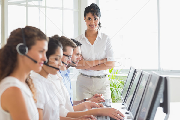 Stock photo: Happy manager working in a call center