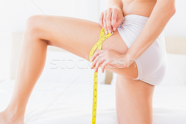 Thin woman measuring her thigh Stock photo © wavebreak_media