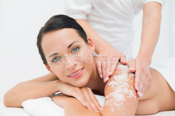 Stock photo: Peaceful brunette getting a salt scrub beauty treatment