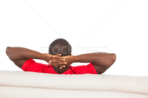 Stock photo: Man in red jersey sitting on couch