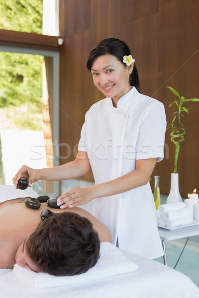 Man receiving stone massage at spa center Stock photo © wavebreak_media