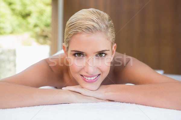 Stock photo: Beautiful woman lying on massage table at spa center