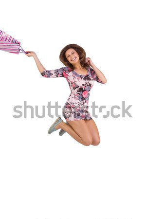 Excited brunette jumping while holding shopping bag Stock photo © wavebreak_media