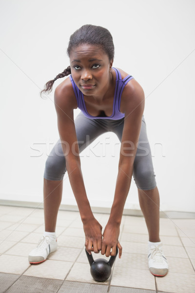 Fit woman lifting up kettlebell Stock photo © wavebreak_media