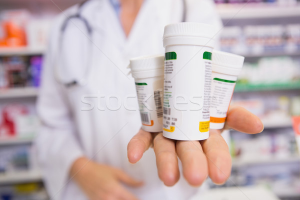 Pharmacist presenting medications on her hand Stock photo © wavebreak_media