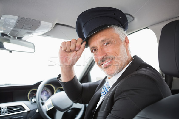 Stock photo: Handsome chauffeur smiling at camera