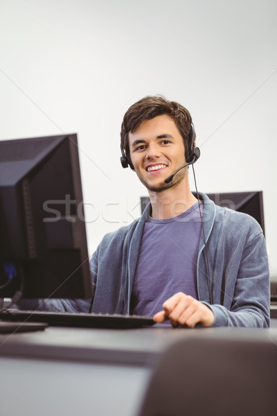 Student sitting at the computer room wearing headset Stock photo © wavebreak_media