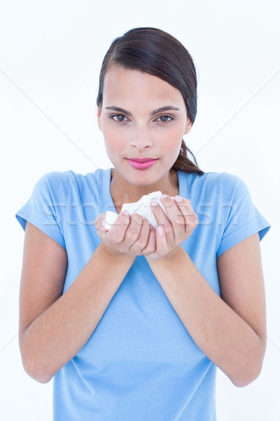 Pretty woman suffering from cold holding tissue Stock photo © wavebreak_media