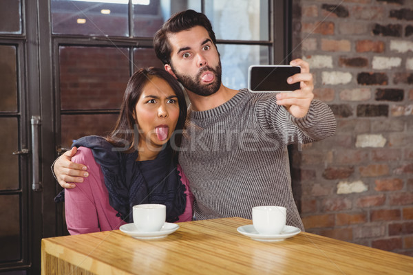 Grimacing friends taking selfies Stock photo © wavebreak_media