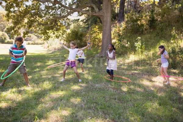 Group of friends playing with hula hoops at campsite Stock photo © wavebreak_media