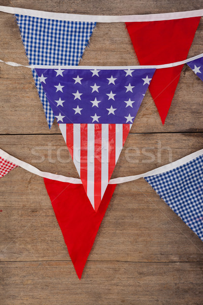 Drapeaux table en bois design fond bleu [[stock_photo]] © wavebreak_media