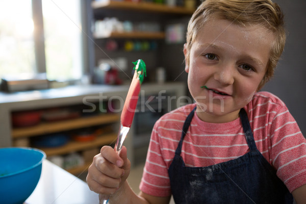 Portrait of boy holding spatula with batter Stock photo © wavebreak_media