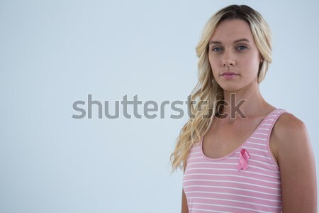 Stock photo: Portrait of young female in tank top with pink ribbon