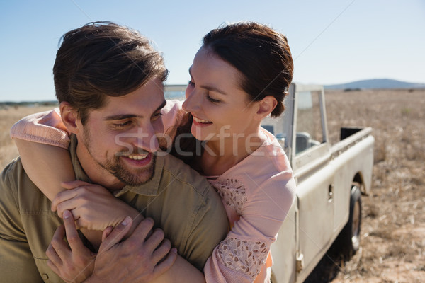 Romantic young couple by off road vehicle Stock photo © wavebreak_media