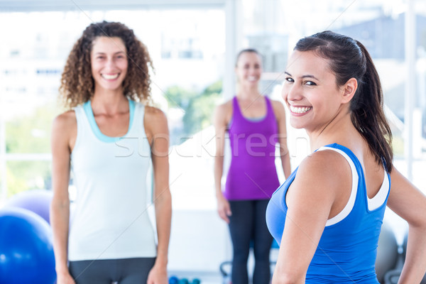 Portrait of cheerful woman with friends at fitness center Stock photo © wavebreak_media