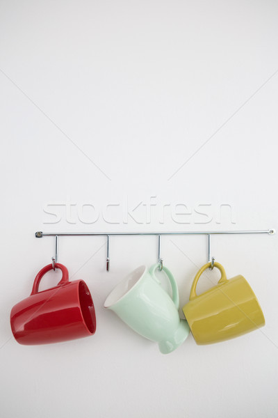 Colorful mugs hanging on hook Stock photo © wavebreak_media