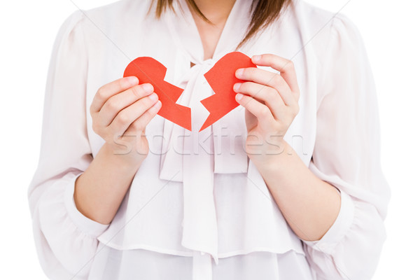 Stock photo: Young woman holding broken heart