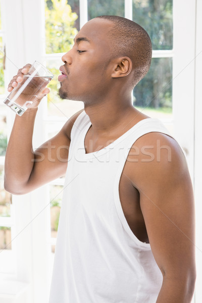 Jeune homme eau potable maison verre Homme mode de vie [[stock_photo]] © wavebreak_media